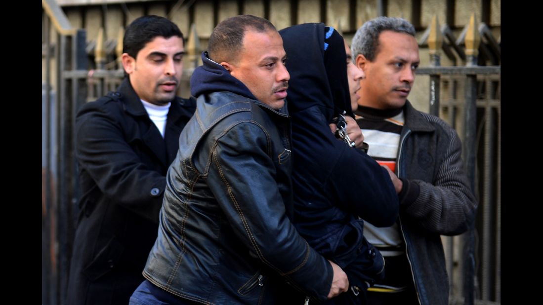 Police in plainclothes detain a youth suspected of being a member of the Black Bloc opposition group during a demonstration on January 30 in Cairo.