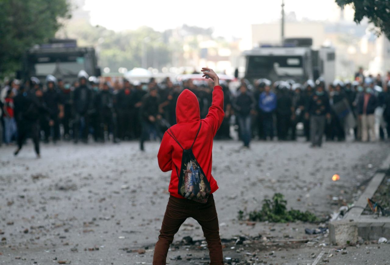 A protester faces off against riot police during clashes near Cairo's Tahrir Square on Wednesday, January 30.