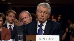 Sen. Chuck Hagel listens as Sen. John McCain grills him over his vote on the Iraq surge
