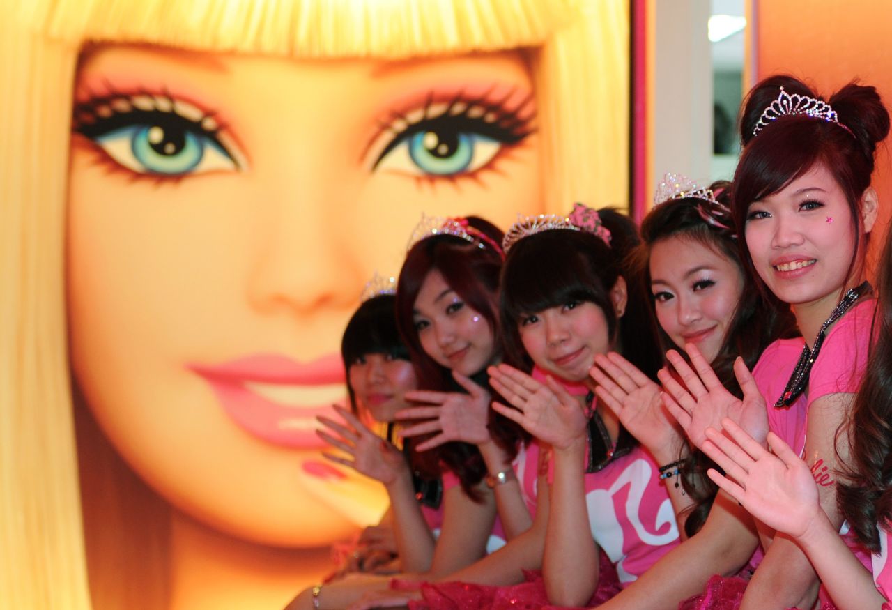 Tiaras and smiles at the opening of Taipei's Barbie Café on Wednesday. This welcome by staff a subtle hint at what lies further ahead.