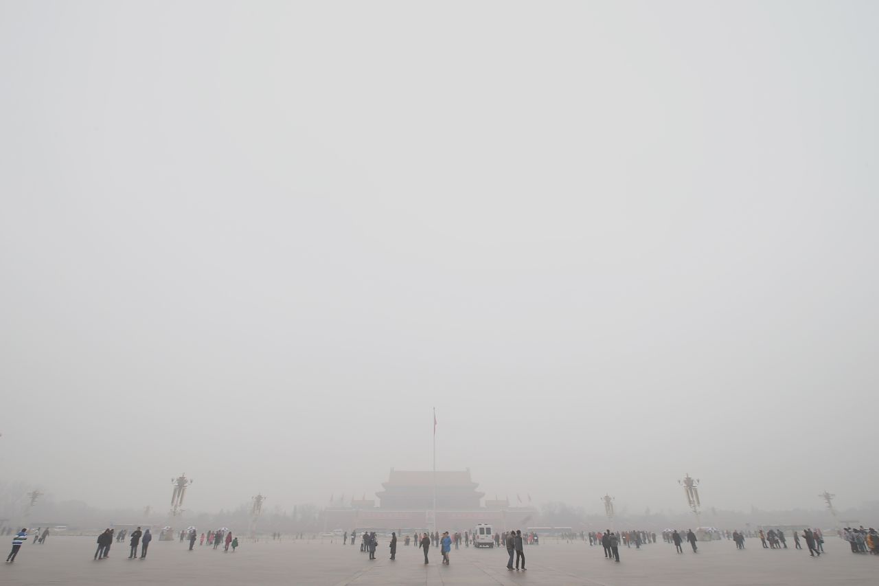 Tourists visit Beijing's Tian'anmen Square during record air pollution in January 2013. The haze that choked many Chinese cities during this time covered 1.43 million square kilometers, said China's Ministry of Environmental Protection.