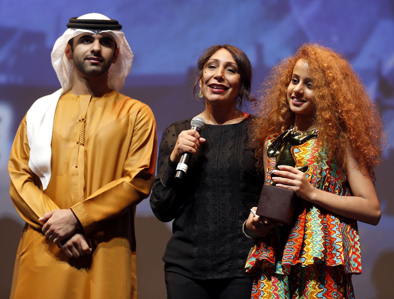 <a href="http://www.imdb.com/name/nm5152687/" target="_blank" target="_blank">Haifaa Al-Mansour</a>, center, directed Saudi Arabia's first feature film, "<a href="http://www.imdb.com/title/tt2258858/" target="_blank" target="_blank">WADJDA</a>", which won best film at the <a href="http://www.dubaifilmfest.com/en/" target="_blank" target="_blank">Dubai International Film Festival </a>in 2011. 