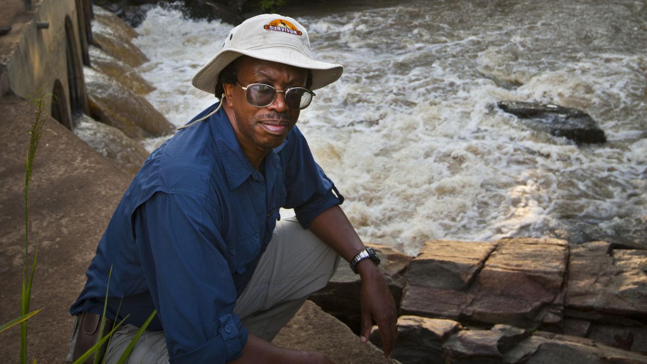 Dr. Moses Katabarwa inspects a fast moving stream of the type where the black flies breed.
