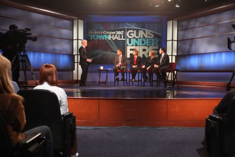 Anderson Cooper hosts panel members, from left, Dan Gross, president of the Brady Campaign; Sandy Froman, former NRA president; Cheryl Olson, who studies video games and violence; and Sanjay Gupta, chief medical correspondent for CNN, at the "Guns Under Fire" town hall event at George Washington University in Washington on Thursday, January 31.