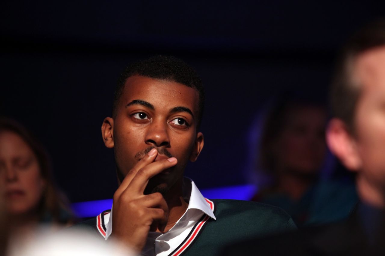 An audience member listens to the debate.