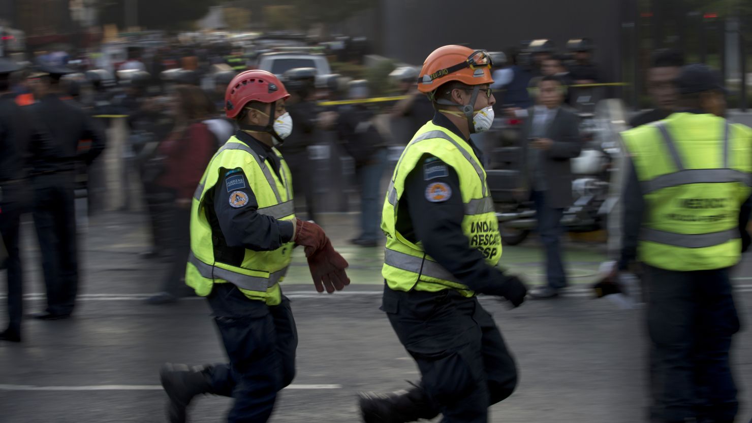 Rescue workers head for the headquarters of state-owned Mexican oil giant Pemex in Mexico City on Thursday.