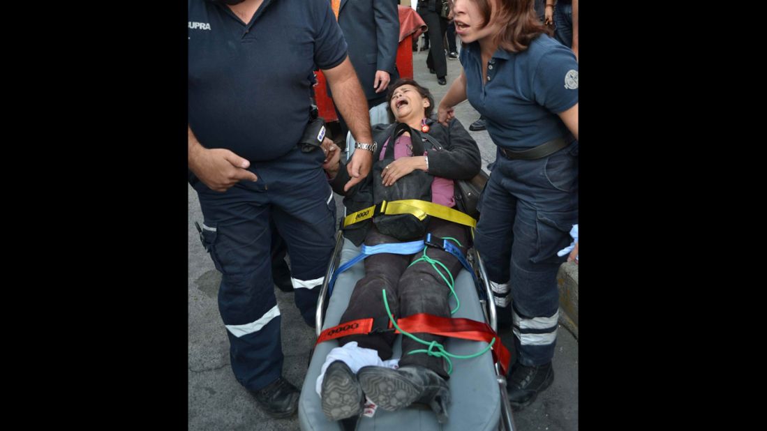 A woman receives medical attention on a stretcher after the explosion.