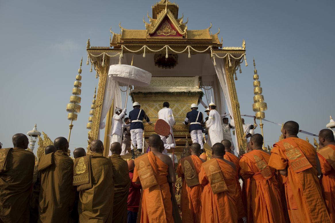 The coffin of the late former King Norodom Sihanouk is lifted onto a chariot in front of the Royal Palace during his funeral procession on Friday.