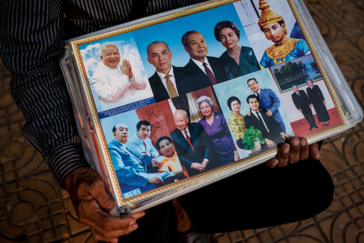 A street vendor sells photographs of former King Norodom Sihanouk outside the Royal Palace on Thursday.