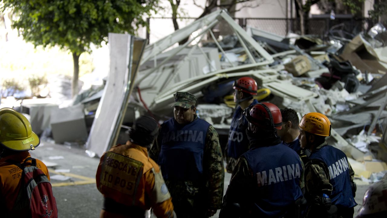 Rescue workers search for victims at the Pemex headquarters in Mexico City on Thursday.