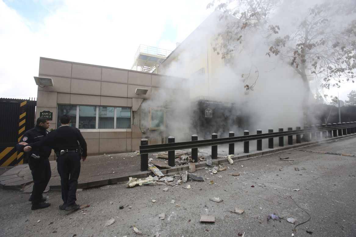 Turkish police officers react after an explosion at the entrance of the U.S. Embassy in Ankara Friday, February 1, in this picture provided by Milliyet Daily Newspaper.