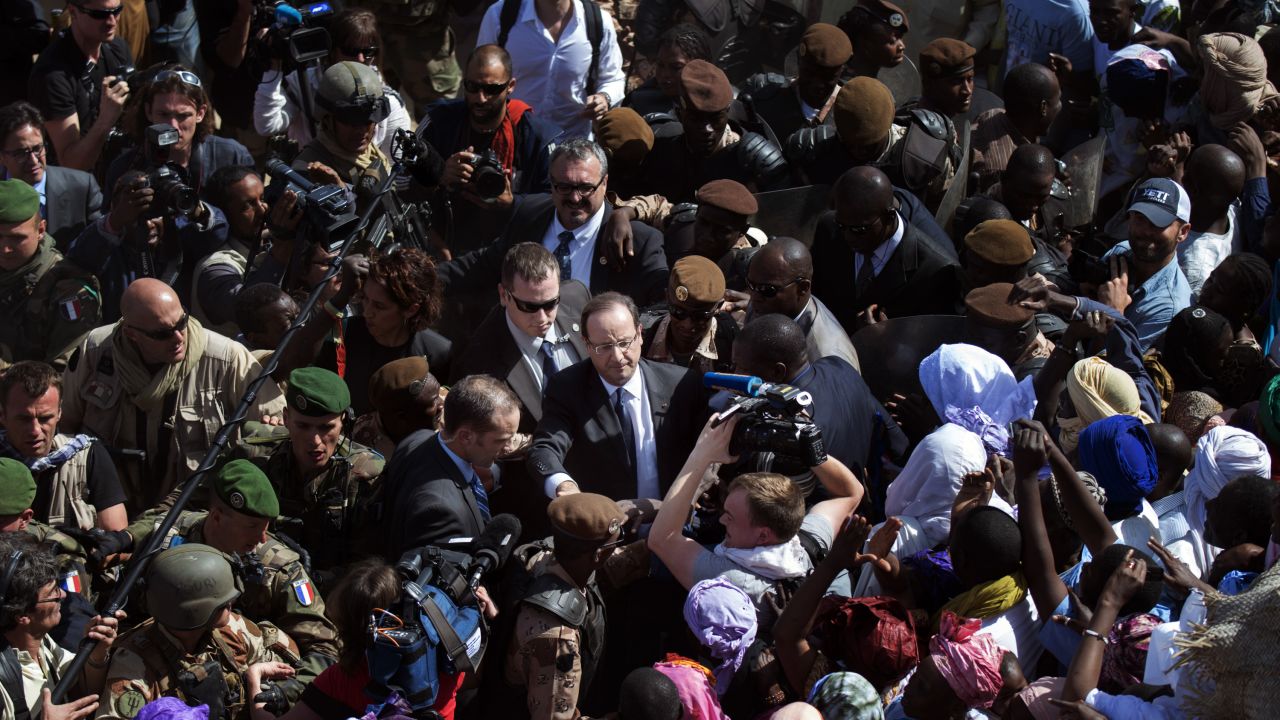 Malians welcome France's President Francois Hollande as he arrives in Timbuktu on Saturday, February 2. French-led troops are working to secure the area against Islamist militants.