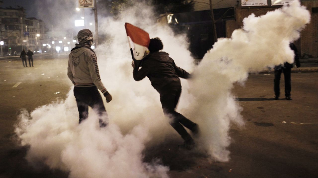 An Egyptian protester throws a tear gas canister toward riot police during clashes outside the Egyptian presidential palace on Friday, February 1, in Cairo. Egypt has been embroiled in violence since last week, the two-year anniversary of an uprising that led to the ouster of then-President Hosni Mubarak.