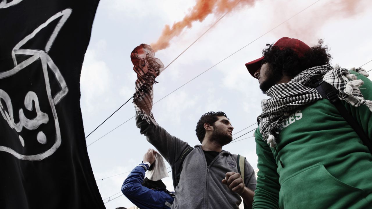 A protester holds a smoke flare outside the presidential palace on February 1.