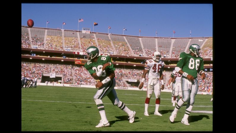 Wide receiver Cris Carter of the Philadelphia Eagles celebrate a touchdown by spiking the ball in the end zone during a game against the Phoenix Cardinals at Sun Devil Stadium in Tempe, Arizona. Carter is also a Hall of Fame selection.