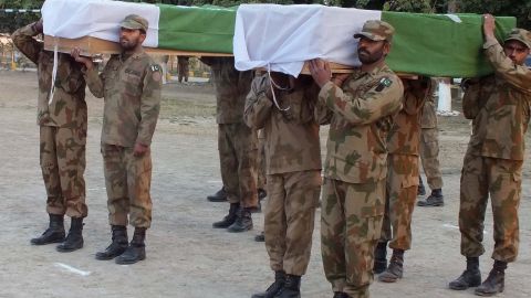 Pakistani soldiers carry the coffins of comrades killed in a suicide attack at a funeral in Sari Norang, February 2, 2013.