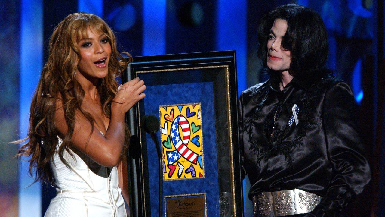 Having stepped out on her own, Beyonce presents the humanitarian award to Michael Jackson at the 2003 Radio Music Awards in Las Vegas on October 27, 2003.
