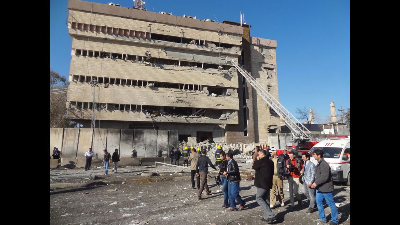 Iraqi rescuers and firefighters work at the scene on February 3.