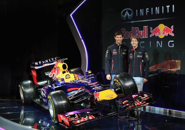 Mark Webber, left, and triple world champion Sebastian Vettel pose with the Red Bull they will be driving this year.