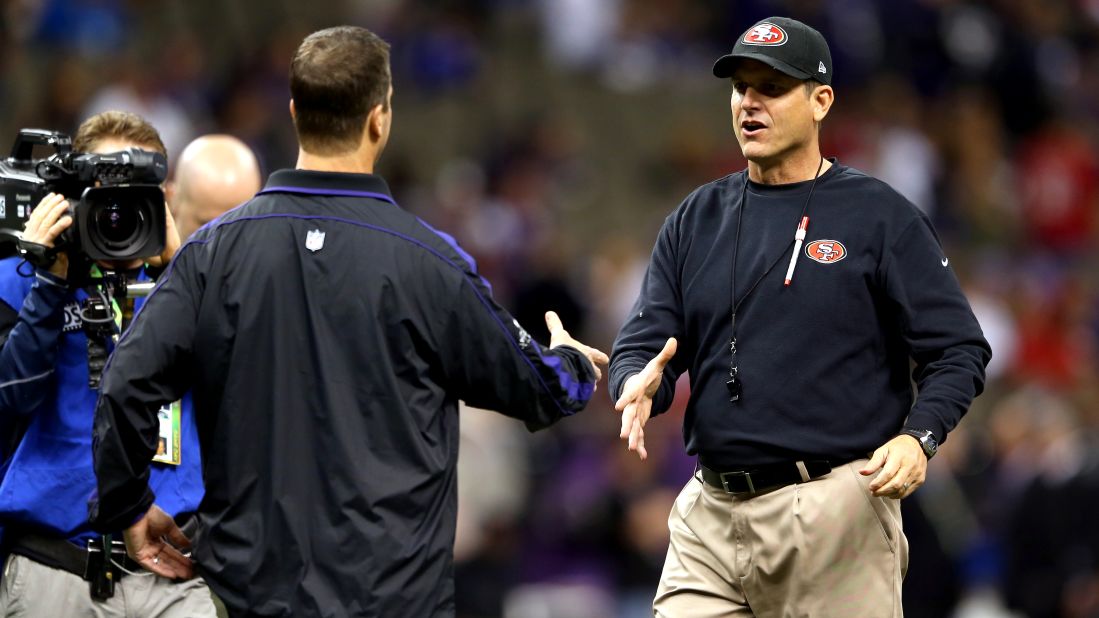Head coach Jim Harbaugh, right, of the San Francisco 49ers shakes hands with his brother, head coach John Harbaugh of the Baltimore Ravens, prior to the start of Super Bowl XLVII.
