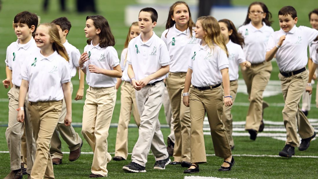 Children in the Sandy Hook Elementary School Chorus walk off the field after singing "America The Beautiful" prior to Super Bowl XLVII.