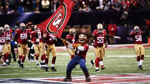 49ers mascot Sourdough Sam waves a flag on the field as players take the field shortly before kickoff.