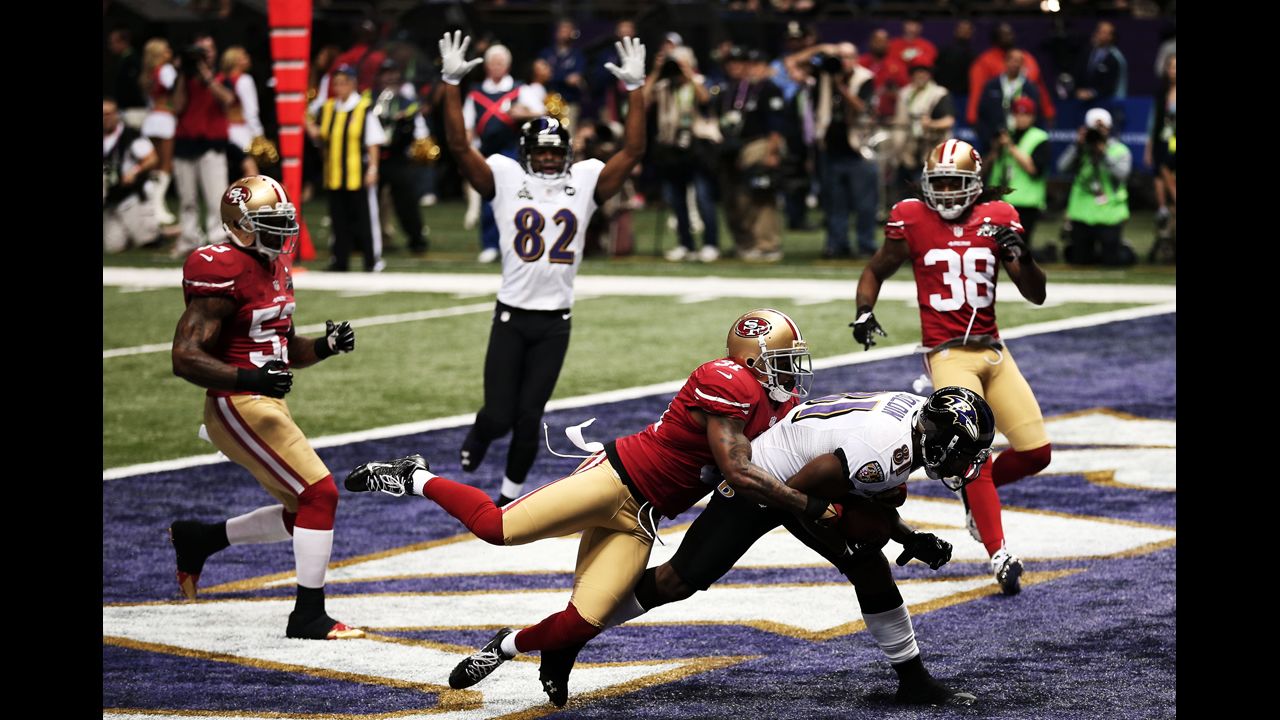 Donte Whitner of the 49ers tries to defend Anquan Boldin of the Ravens.