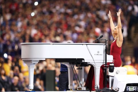 Alicia Keys reaches into the air during her rendition of the National Anthem.