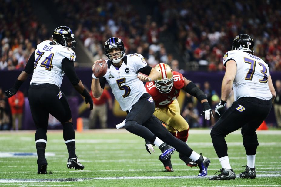 Ravens quarterback Joe Flacco scrambles with the ball against 49ers defensive end Ray McDonald.