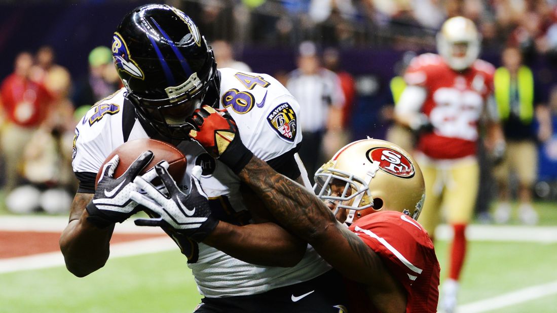 Donte Whitner of the San Francisco 49ers commits a face mask penalty against Ed Dickson of the Baltimore Ravens in the second quarter.