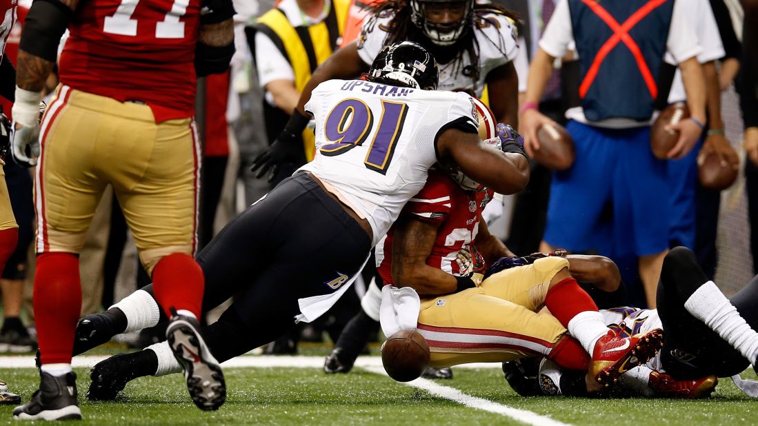 Courtney Upshaw of the Ravens forces LaMichael James of the 49ers to fumble in the second quarter.