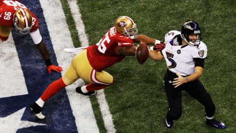 Quarterback Joe Flacco of the Ravens attempts to escape pressure from Ahmad Brooks of the 49ers.
