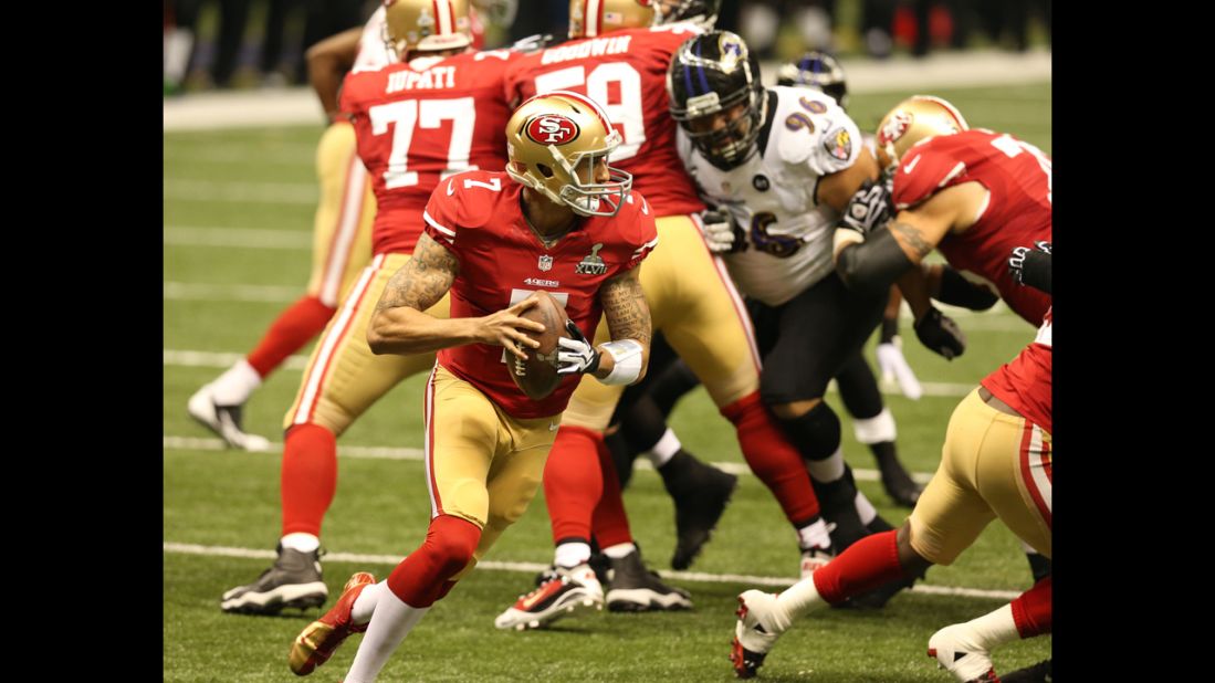 Quarterback Colin Kaepernick of the 49ers rolls out of the pocket and looks to pass during the second quarter.