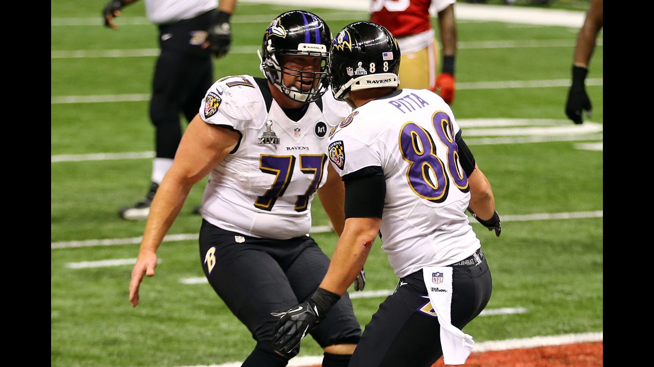 Dennis Pitta of the Baltimore Ravens, right, celebrates with teammate Matt Birk after catching a touchdown pass in the second quarter.