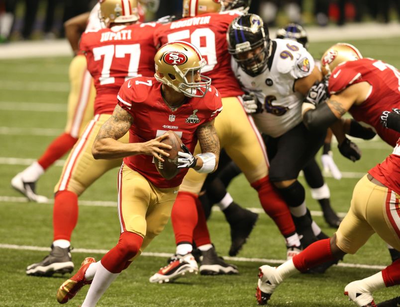 Quarterback Colin Kaepernick of the San Francisco 49ers rolls out of the pocket against the Ravens.