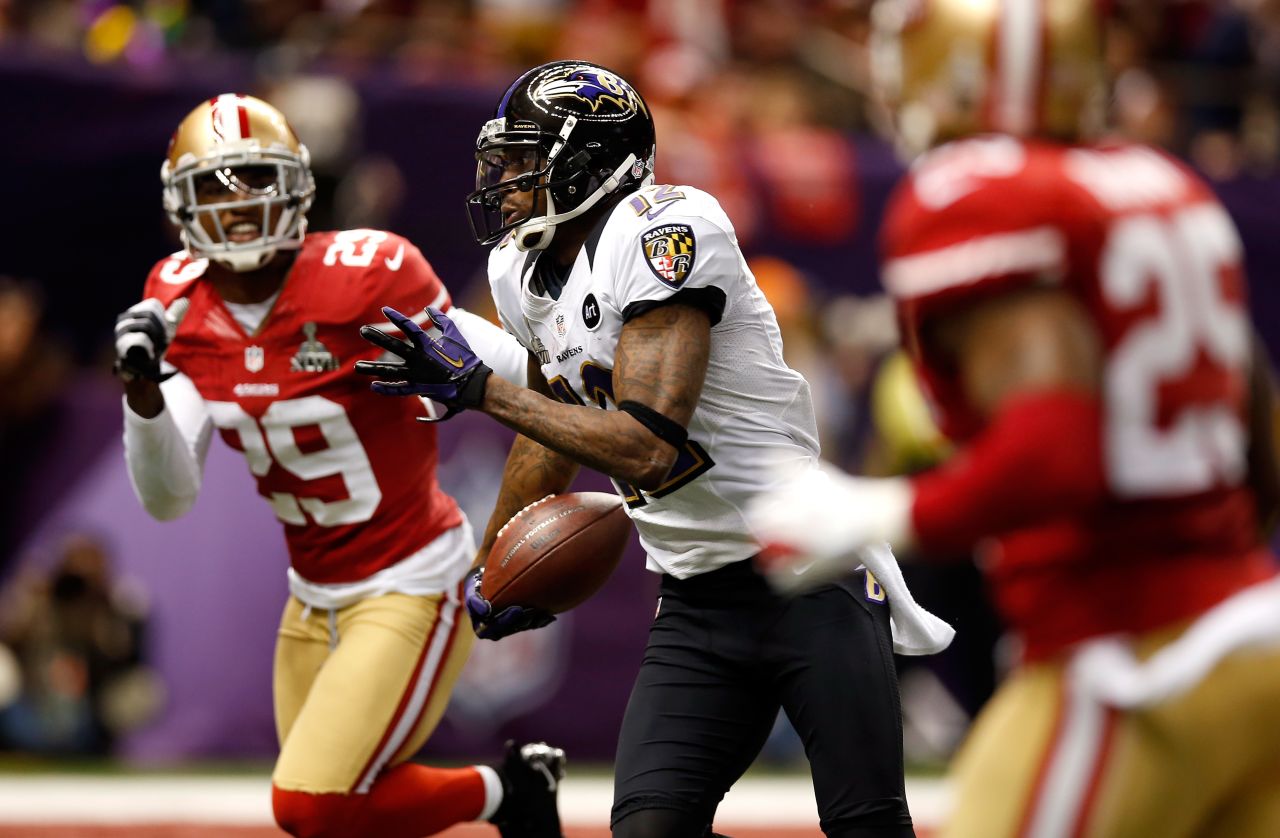 Jacoby Jones of the Ravens runs on a 56-yard touchdown pass past  Chris Culliver of the San Francisco 49ers.