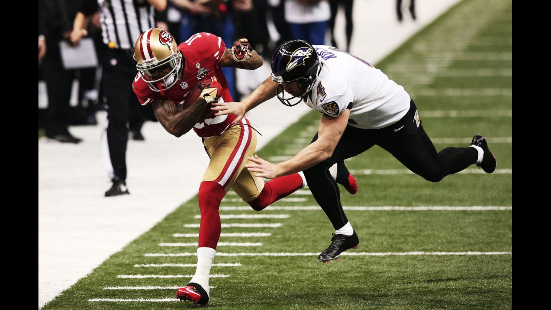 Ted Ginn Jr. of the 49ers returns a punt 32 yards against Sam Koch of the Ravens.