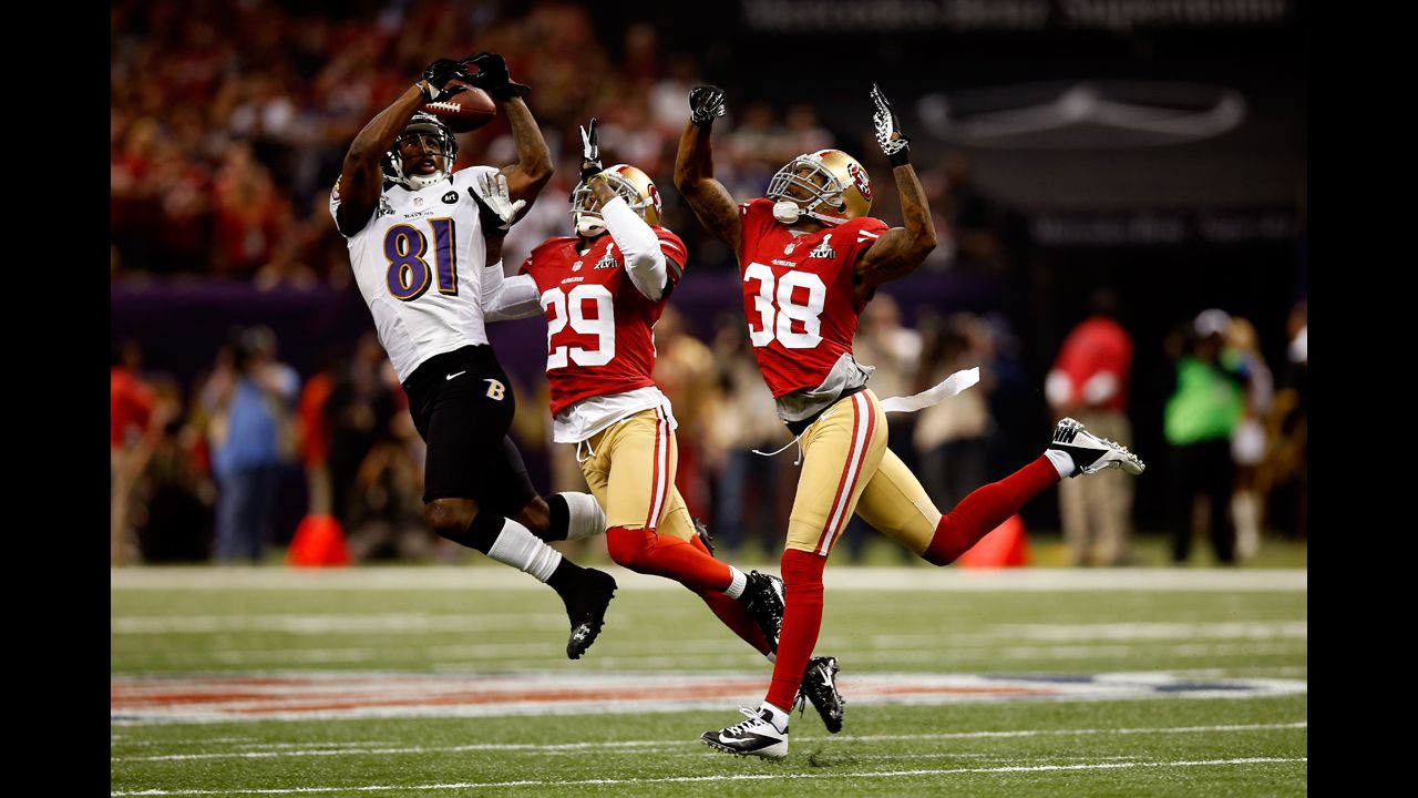 Anquan Boldin of the Baltimore Ravens attempts to catch a pass in front of Chris Culliver, center, and Dashon Goldson of the San Francisco 49ers.