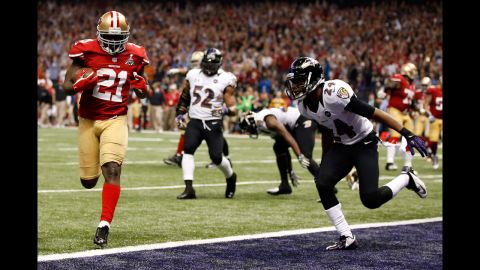 Frank Gore of the 49ers runs in for a touchdown in the third quarter past Corey Graham of the Ravens.