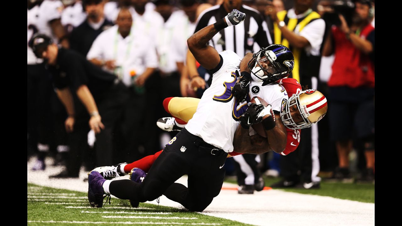 Bernard Pierce of the Baltimore Ravens is tackled by Dashon Goldson of the 49ers.