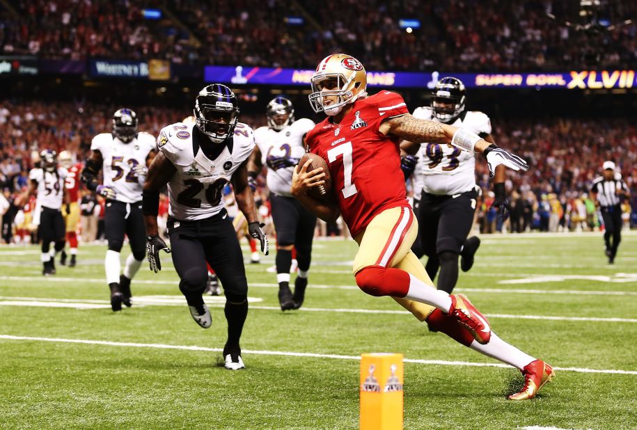 Quarterback Colin Kaepernick of the 49ers scores a 15-yard rushing touchdown in the fourth quarter against the Ravens.