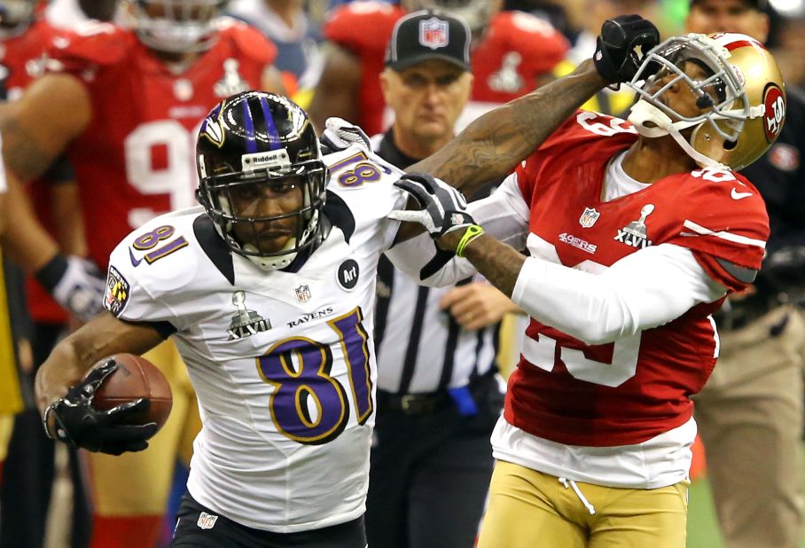 Anquan Boldin of the Baltimore Ravens stiff-arms Chris Culliver of the San Francisco 49ers after catching a 30-yard pass in the third quarter.