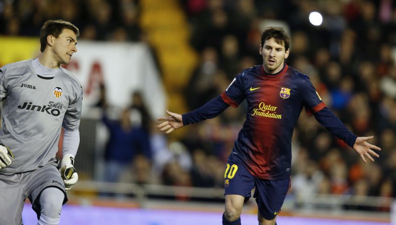Barcelona forward Lionel Messi (right) celebrates after scoring from the penalty spot in the 1-1 draw against Valencia.