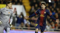 Barcelona forward Lionel Messi (right) celebrates after scoring from the penalty spot in the 1-1 draw against Valencia.