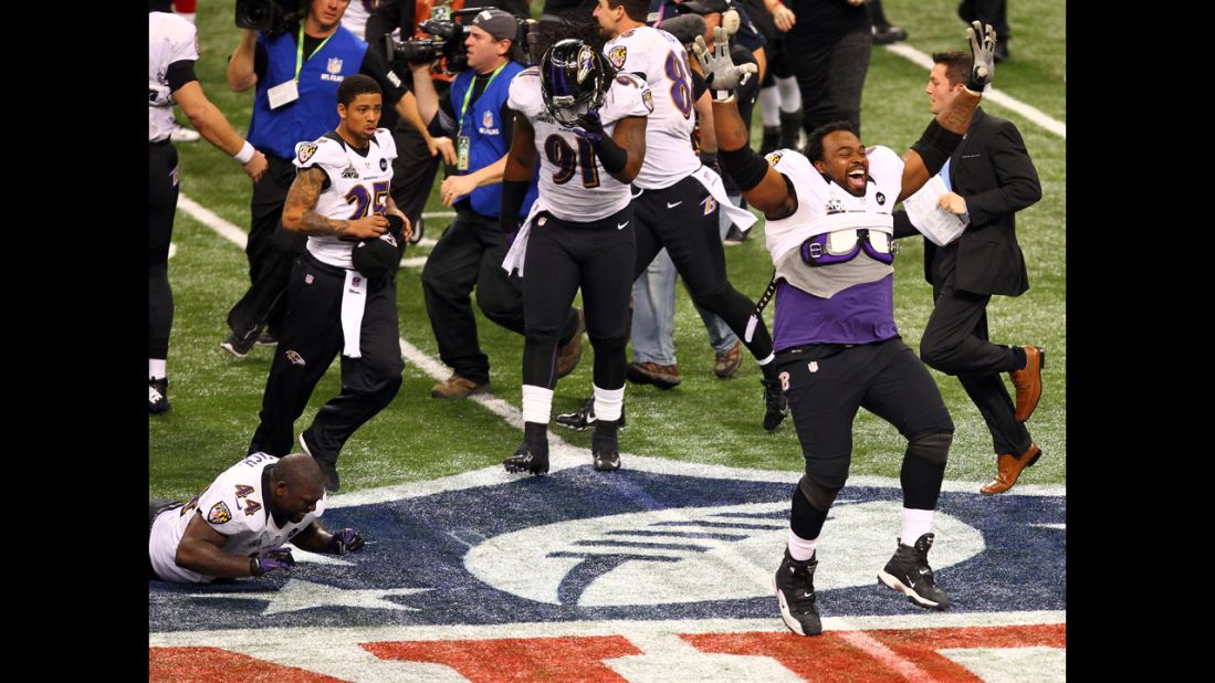 Bobbie Williams of the Baltimore Ravens, right, and his teammates celebrate their win against the San Francisco 49ers.