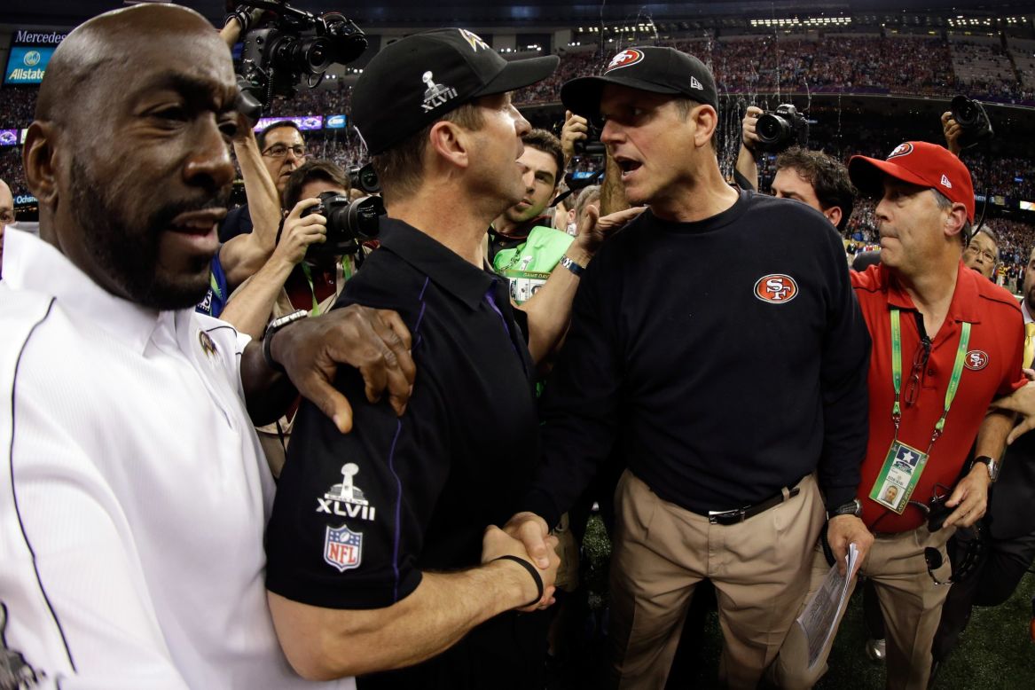 Head coach John Harbaugh of the Baltimore Ravens, left, shakes hands with his brother, head coach Jim Harbaugh of the San Francisco 49ers, after winning Super Bowl XLVII in a close contest.