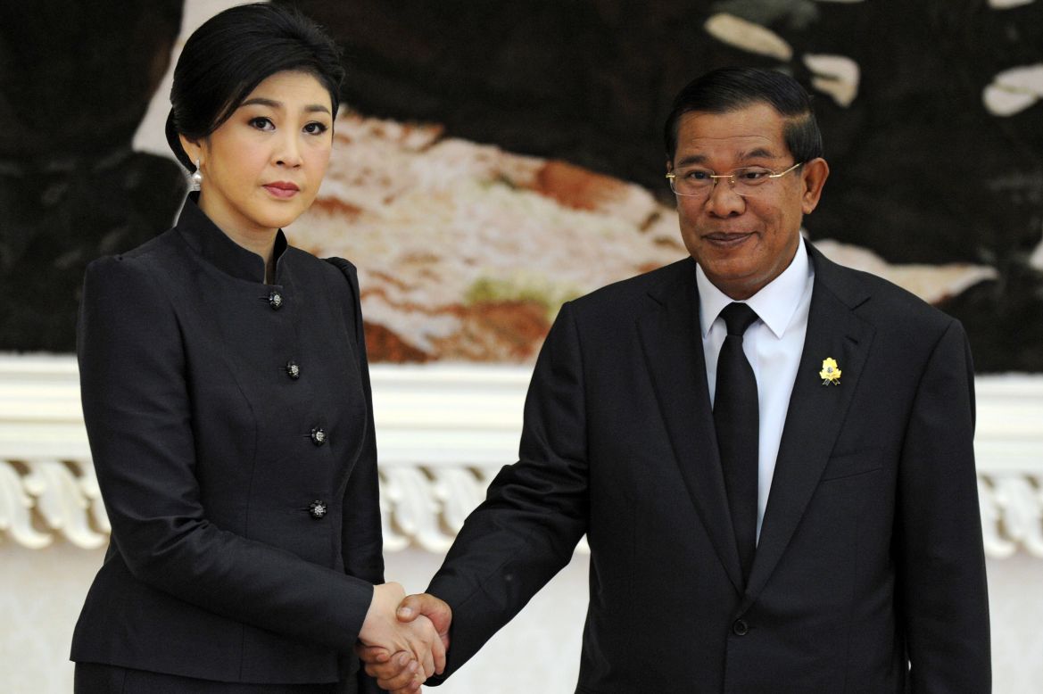 Thai Prime Minister Yingluck Shinawatra (L), in town to pay her respects to the late king, shakes hands with Cambodian Prime Minister Hun Sen (R) during a meeting at the Peace Palace in Phnom Penh Monday.