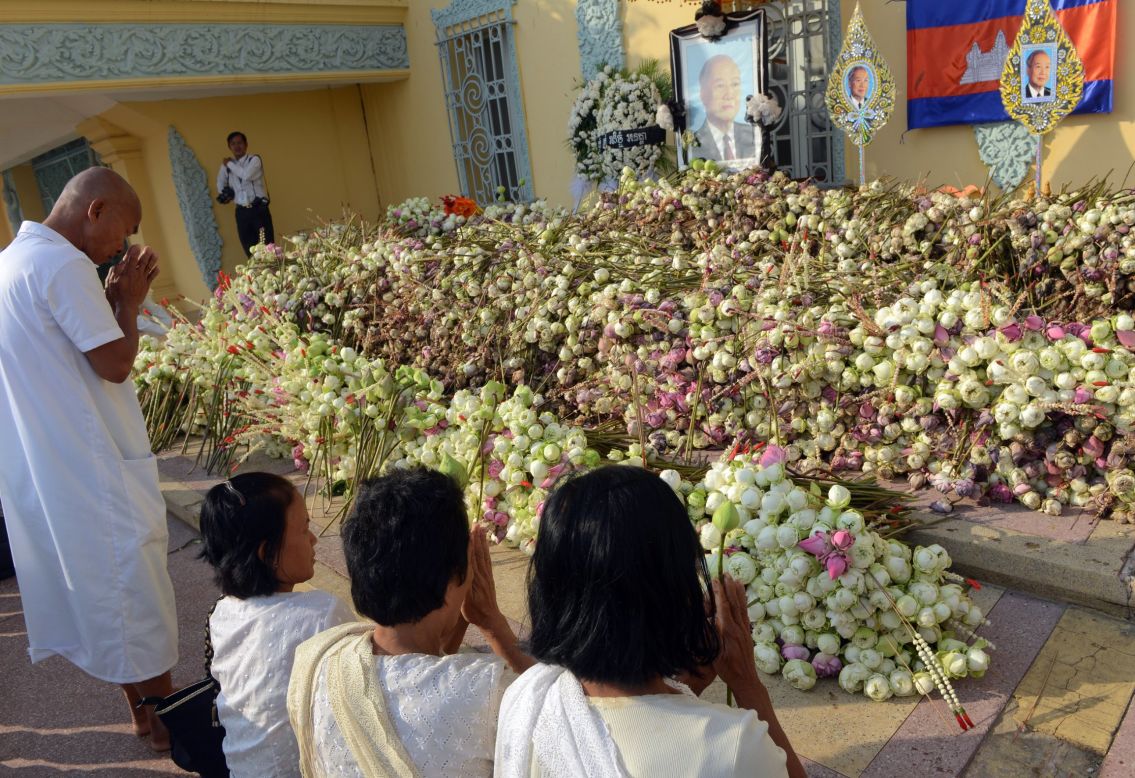 Cambodians pray for their late former king Norodom Sihanouk in front of the Royal Palace in Phnom Penh on Sunday.