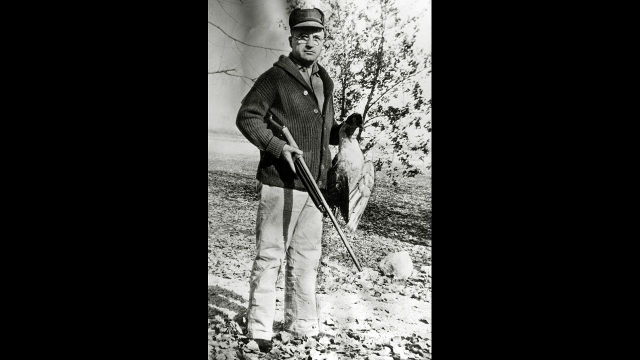 Harry S. Truman holds a bird on a hunting trip in Missouri in January 1930.