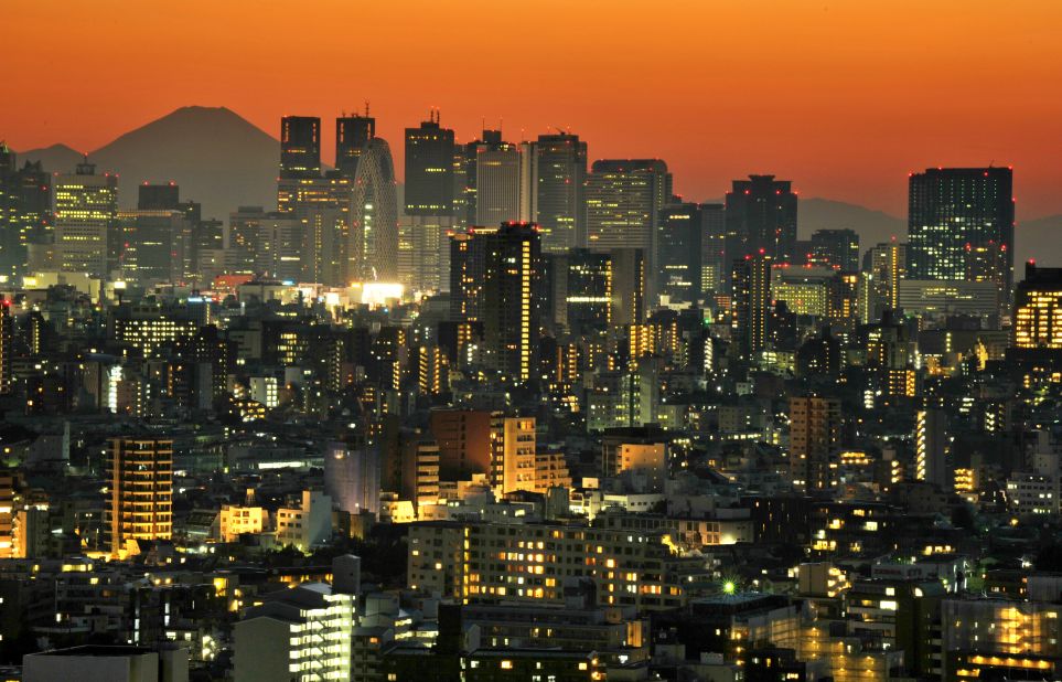 Japan's highest mountain Mount Fuji rises up behind the skyscrapers dotting the skyline of the Shinjuku area of Tokyo, where ultra luxury property sells an average of £5,000 ($7,550) per square foot.